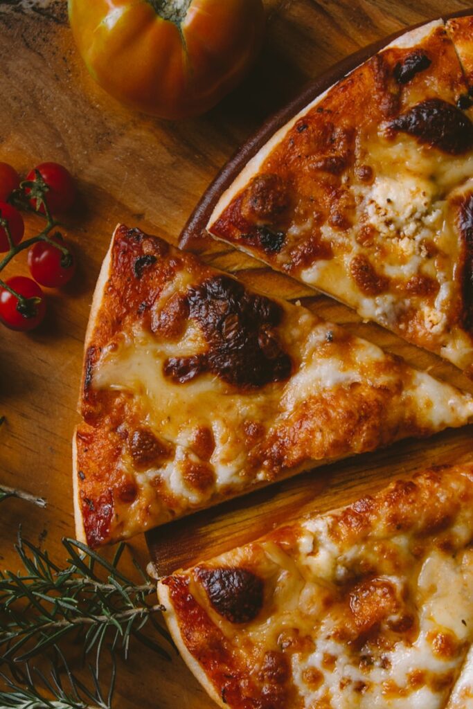 Pizza cut up into slices on table